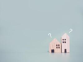 Miniature house with question mark icons.The concept of choosing suitable house for planning living in the future. Real estate photo