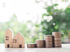 Miniature house and stack of coins. The concept of saving money for house, Property investment, House mortgage, Real estate. photo