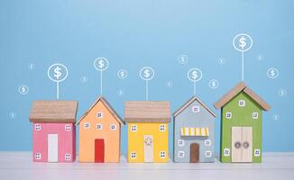 Miniature house and Dollar coin icons. The concept of price of house, Property investment, House mortgage, Real estate photo