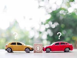 Toy car with question mark and Dollar coin icons.The concept of choosing for buying car photo