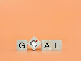 Wooden blocks with the word GOAL. The concept of Goal achievement , target, strategy and success photo