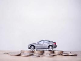 Toy cars on stack of coins. The concept of saving money and manage to success transport business photo