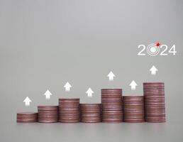 Stack of coins with arrow rising. The concept of business growth, Financial investment, Market stock, Profit return, Dividend and Business fund in year 2024 photo