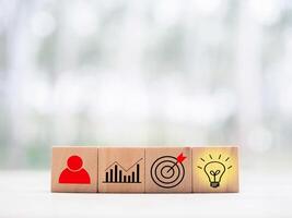 Wooden block with  business strategy icons, Action plan and business process management concept. photo