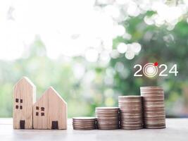 Miniature house and stack of coins. The concept of payment tax for house, Property investment, House mortgage, Real estate in New Year 2024. photo