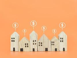 Miniature house and Dollar coin icons. The concept of price of house, Property investment, House mortgage, Real estate photo