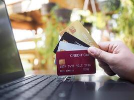 Woman hand holding several credit cards. The concept of Convenience in the world of technology and the internet, Online shopping, banking transaction, banking online and payment photo