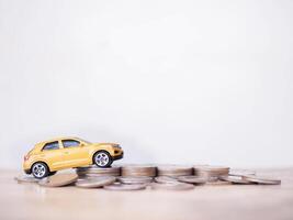 Toy cars on stack of coins. The concept of saving money and manage to success transport business photo