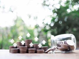 Stack of coins with arrow rising icons. The concept of business growth, Financial investment, Market stock, Profit return, Dividend and Business fund. photo