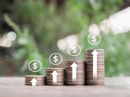 Stack of coins with arrow rising and dollar coin icons. The concept of business growth, Financial investment, Market stock, Profit return, Dividend and Business fund. photo