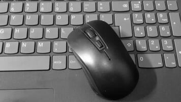 image of a black laptop keyboard and mouse photo