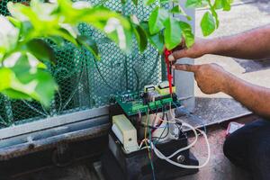 Electrical engineer checking circuit board at home. photo