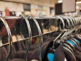 Shopping concept, rack of hangers in the foreground photo