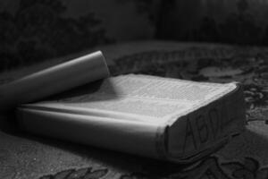 image of an open book on a table photo