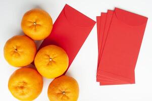 Top view of Mandarin oranges and Chinese New Year red envelope. Chinese New Year celebration concept photo