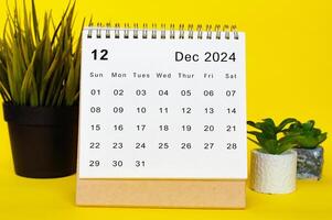 December 2024 calendar with yellow over background. Monthly calendar concept photo