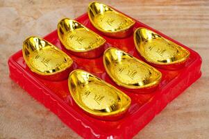 Golden ingots on wooden table. Wealth and abundance concept photo