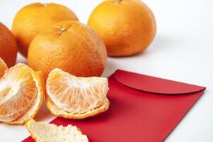 Pealed Mandarin orange on top of Chinese New Year packet photo