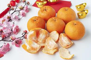 Top view of Pealed Mandarin oranges on white cover background. Chinese New Year celebration. photo