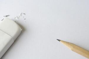 Top view of eraser and pencil on white cover background with customizable space for text photo