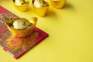 Golden ingot on top of red packets with customizable space for text or wishes photo