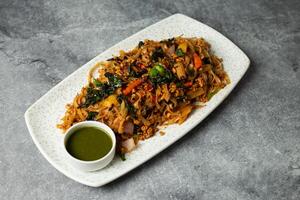 Thai Basil Noodles with sauce served in dish isolated on background top view of bangladesh foodstreet food photo