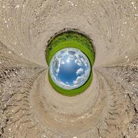 blue hole sphere little planet inside sand round frame background photo