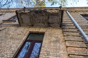 balcony with decorative elements on an old brick building photo