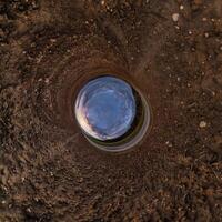 agujero azul esfera pequeño planeta dentro de hierba verde fondo de marco redondo foto