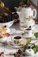 fruit tea with ripe blackberries, vintage still life with beautiful retro set photo