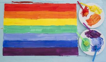 flag in the colors of the rainbow, as support for the minority community is painted with paints casually, LGBTq pride, holiday photo