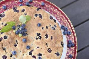 Large freshly baked homemade blueberry pie, summer food, close up photo