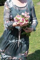 middle-aged woman with a bouquet of pink eustomas a gift for mother's day,spring photo