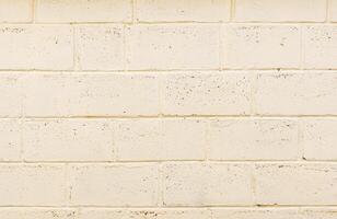 freshly painted wall structure made of light beige foam concrete blocks, texture of wall fragment photo