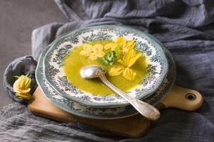 calabaza sopa en un plato con un azul ornamento otoño menú, vegetariano comida foto