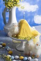 Traditional Easter Orthodox curd cake with yellow flowers against a blue sky photo