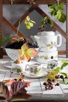fruit tea with ripe blackberries, vintage still life with beautiful retro set photo