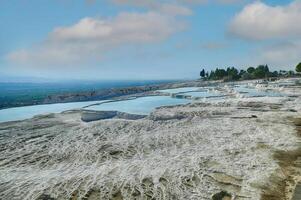 Calcium deposits  on travertine turquoise  terraced pools at  Pamukkale photo