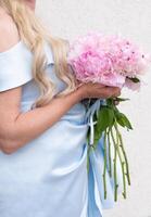 bride in a blue wedding dress with a bouquet of pink peonies, pastel paradise photo