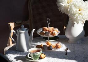 tea break in english style, vintage still life, homemade buns, a bouquet dalias photo