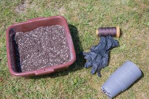 preparing pots for seedlings,filling with nutrient soil,seasonal work spring in the garden photo