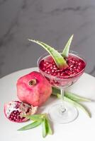 bright pomegranate juice with aloe vera, delicious alternative medicine photo