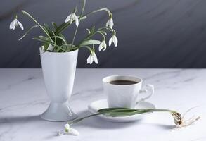 still life with spring white snowdrops and a porcelain cups photo