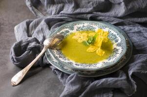 pumpkin soup in a plate with a blue ornament autumn menu, vegetarian food photo