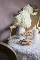 tea break in english style, vintage still life, homemade buns, a bouquet dalias photo