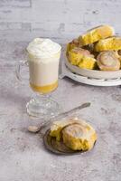 pumpkin cinnabons and latte for dessert, holiday table with pastries, home sweet photo