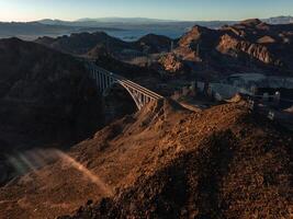 Hoover Dam on the Colorado River straddling Nevada and Arizona at dawn from above. photo