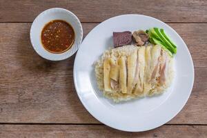 Hainanese chicken rice consists of blood, chicken entrails and a spicy dipping sauce. It is a delicious, mellow food. It is a food that is easily found in Thailand and is a street food. photo