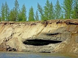 Crumbled cliff on the river bank. photo