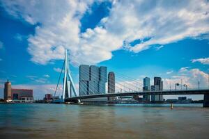 View of Rotterdam cityscape with Erasmusbrug bridge over Nieuwe Maas and modern architecture skyscrapers photo